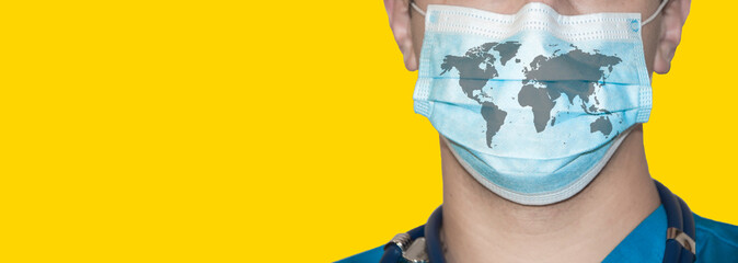 medical worker in overalls. epidemiologist in protective uniform. coronavirus problem concept. doctor in mask on yellow background. world map on medical mask