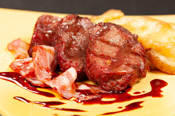 grilled meat with bacon and potatoes