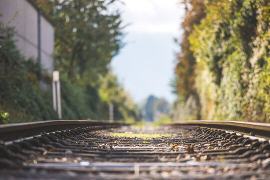 Sustainable traveling by train: Rail track and colorful, idyllic landscape in fall.