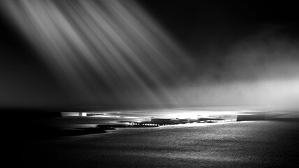 Dark street, black background, glare of light on the wet asphalt. Rays and lines, smoke. Dark city...