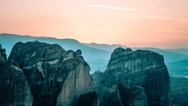 Sunset view over unique rock formations and mountains in Meteora, Greece © Jack Krier
