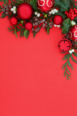 Christmas background border with red ball baubles & winter greenery of holly, ivy, mistletoe....