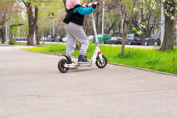 Girl riding a scooter in the city