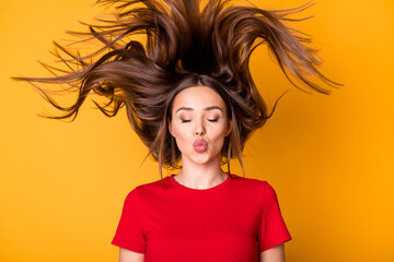 Photo of lady with flying hairstyle sending air kisses wear casual red top isolated yellow bright...