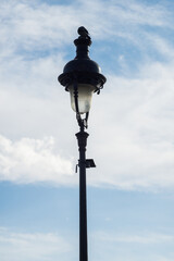 Fototapeta na wymiar Closeup of street light from Montmartre quarter in Paris on beautiful blue cloudy sky background