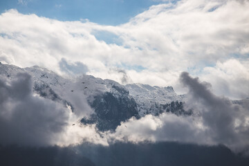 Fototapeta na wymiar Snowy mountain Untersberg with clouds, snow and blue sky, Austria