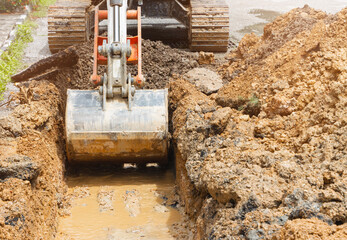 backhoe dig repair broken water line pipe main plumbing on road
