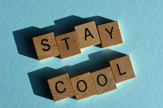 Naklejki Stay Cool, words in wooden alphabet letters isolated on blue background
