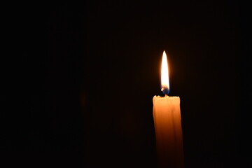 Burning candle in the dark