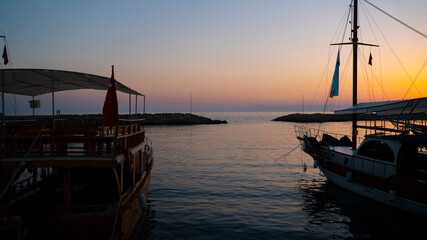 Fototapeta premium Tourist boats in the marina at sunset