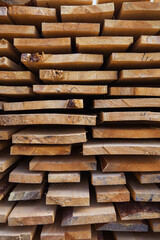 Building material in the form of fresh wooden planks at a road repair site. The repair process.