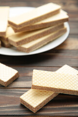 Chocolate wafers on plate on brown background