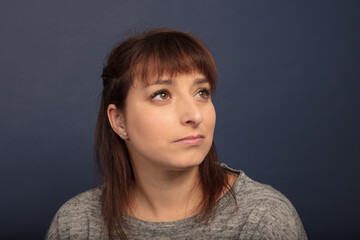 woman in her thirties looking up studio portrait