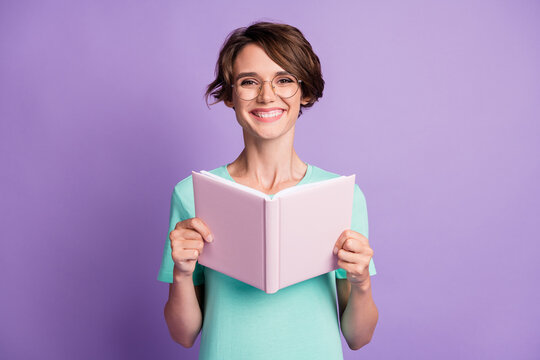 Photo of sweet optimistic short brown hairdo lady read planner wear spectacles blue t-shirt isolated on violet background