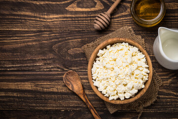 Curd or cottage cheese at wooden table.