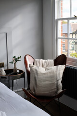 Cosy corner of design led bedroom with an English village view from the window