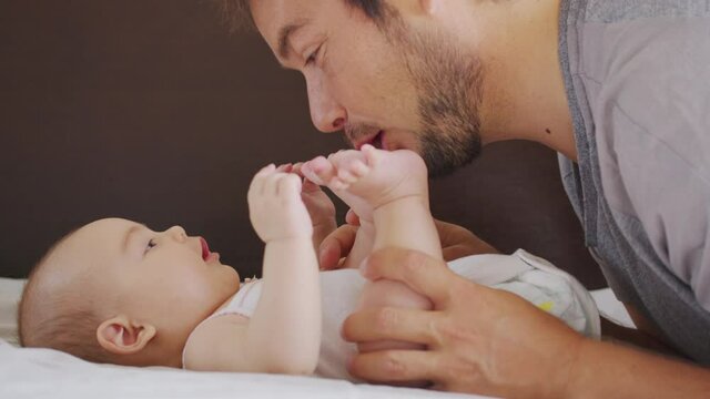 Happy family. Portrait of bearded father and newborn baby girl hugging. Paternity Parenthood happiness. Loving dad enjoying caring playing with little child. healthy childcare, love.