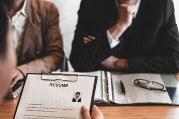 Examiner reading a resume during job interview at office Business and human resources concept