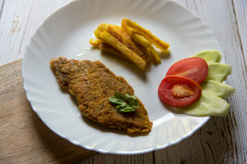 Close up of  fish and chips along with salad in a plate