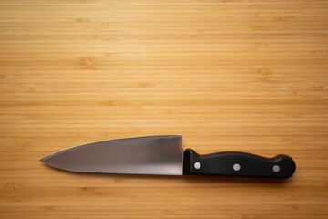 Knife on the background of a board for cutting a wooden