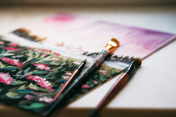 Fototapeta premium Paint bruhes on the canvas. Drawing nature in the process