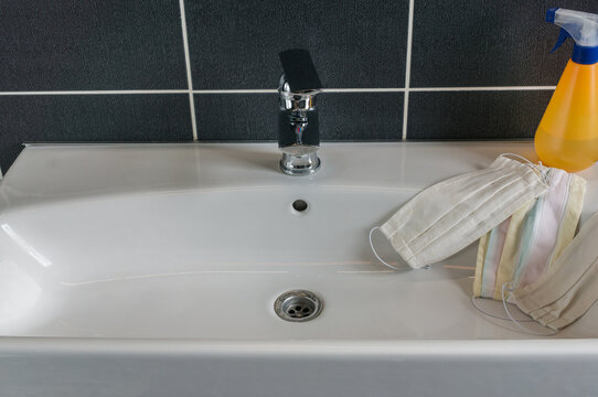  white and color textile homemade mask laid on the sink