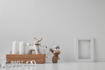 Fototapeta na wymiar Porcelain figurine of a New Year's deer and New Year's, festive decor. Copy space, mock up.