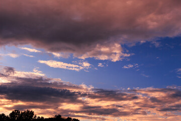 Sky with some dramatic clouds and vibrant colors at golden hour