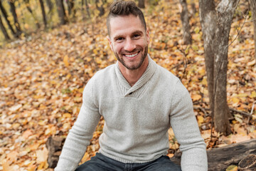 Mature man on autumn leaves feeling great