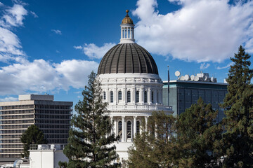 California State Capitol building dome in Sacramento with cloudy sky. © trekandphoto