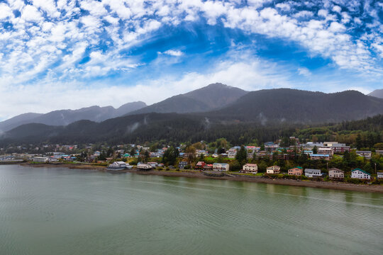 Beautiful view of a small town, Juneau, with mountains in the background. Blue Sky Sunny Day. Taken in Alaska, United States.