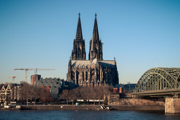 Fototapeta na wymiar The Hohenzollern bridge over Rhine river on a sunny day. The Cologne Cathedral (Kolner Dom) in the city of Cologne, Germany. It is the largest Gothic church in northern Europe.