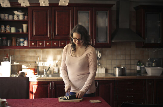 woman prepares dinner in the kitchen