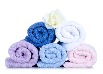 Fototapeta na wymiar Rolled towels with flower on white background isolation