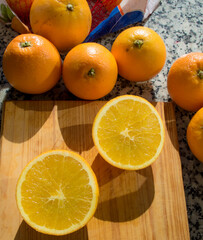 Naranjas y mitades, sobre una tabla de madera