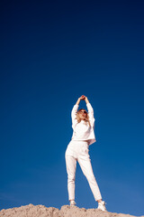 Beautiful fashionable young woman dressed in white sportswear outdoor autumn