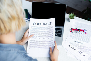 back view of woman looking at contract