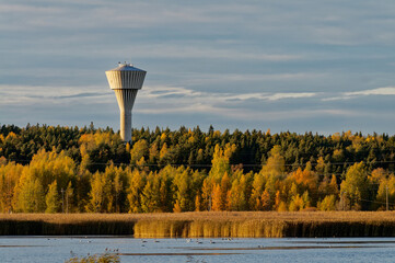 Water tower on the lake in autumn.