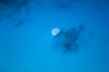 moon behind the cloud in the morning
