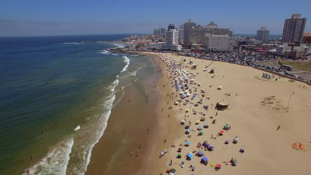 Aerial tilt up shot showing famous Playa Brava beach and cityscape of Punta del Este during summer in Uruguay, South America. 