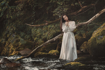 Beautiful woman in fairy fantasy forest