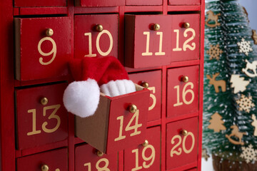 Red wooden Advent calendar with surprise for Christmas