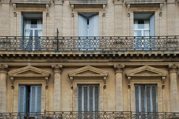 Fototapeta na wymiar Typical French facade with balconies and shutters in south France