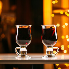 Two glass mugs of glintwine with blurry lights