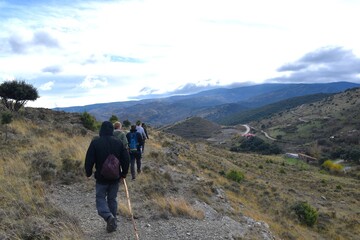 Hikers with backpacks on a mountain walk in the Cidacos Valley.