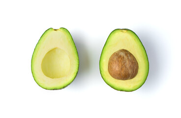 Avocado with a stone cut in half on a white background. Fresh fruit, top view. The concept of natural products.