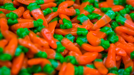 Background - assortment of delicious marmalade jelly candies for sale on counter of shop, grocery, market, cafe. Dessert, copy space, sweet food, pattern and confectionery concept