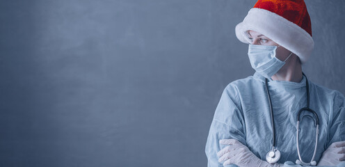 doctor in medical mask and santa on gray background with place for text