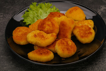 Fried chicken nuggets served salad leaves