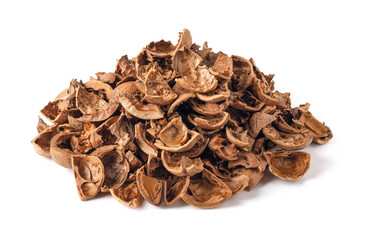 Pile of empty broken walnut shells isolated on white background. Biodegradable food waste and peelings. Nut crop concept.